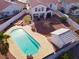 Aerial view of a private backyard with a pool, landscaping, storage shed, and perimeter privacy fencing at 504 Landra Ln, Henderson, NV 89015