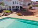 Aerial view of a private backyard with a pool, lush landscaping, and a beautiful home at 504 Landra Ln, Henderson, NV 89015