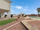 Lush backyard offers a sparkling pool, a storage shed, a grassy area, and desert landscaping at 504 Landra Ln, Henderson, NV 89015