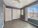 Bedroom with large window, ceiling fan, and ample closet space at 504 Landra Ln, Henderson, NV 89015