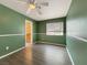 Comfortable bedroom with wood floors, a ceiling fan, and neutral paint and trim throughout at 504 Landra Ln, Henderson, NV 89015
