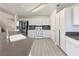 Well-lit kitchen with white cabinets, stainless steel appliances, and a view of the staircase at 504 Landra Ln, Henderson, NV 89015