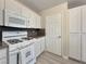 Kitchen features a white gas range, white cabinetry, and light gray countertops at 504 Landra Ln, Henderson, NV 89015