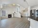 Bright living room featuring a cozy fireplace, high ceilings, and luxury vinyl plank flooring at 504 Landra Ln, Henderson, NV 89015