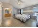 Inviting main bedroom boasts neutral tones, a ceiling fan, and an ensuite bathroom for added privacy at 504 Landra Ln, Henderson, NV 89015