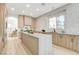 Modern kitchen featuring wood cabinets, a waterfall island, and stainless steel appliances at 5737 Heather Breeze Ct, Las Vegas, NV 89141