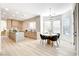 A light-filled kitchen and dining area with a stylish chandelier and a table with chairs at 5737 Heather Breeze Ct, Las Vegas, NV 89141