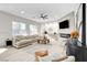 Bright living room featuring a fireplace, a large sofa and views from large windows at 5737 Heather Breeze Ct, Las Vegas, NV 89141