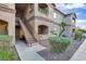Condo building features a covered entrance, second story balconies, and landscaped grounds at 5751 E Hacienda Ave # 119, Las Vegas, NV 89122
