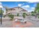 Attractive building exterior with well-maintained landscaping and a charming communal picnic area at 5751 E Hacienda Ave # 119, Las Vegas, NV 89122