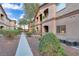 Condo building features covered entrances, second story balconies, and landscaped grounds at 5751 E Hacienda Ave # 119, Las Vegas, NV 89122