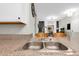 Kitchen sink with granite countertop, with a living room view and natural light at 5751 E Hacienda Ave # 119, Las Vegas, NV 89122