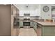 Kitchen with stainless steel appliances, light green cabinets and granite countertops at 5751 E Hacienda Ave # 119, Las Vegas, NV 89122