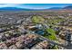 Gorgeous community aerial view with desert mountain backdrop, showcasing its golf course, pool, and landscaping at 580 Via Di Parione Ct, Henderson, NV 89011
