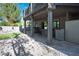 The covered patio provides shade over a full outdoor kitchen and bar area, overlooking the manicured backyard at 580 Via Di Parione Ct, Henderson, NV 89011