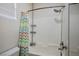 Clean bathroom showcasing a shower with a patterned curtain and modern fixtures at 580 Via Di Parione Ct, Henderson, NV 89011