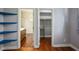 Bedroom featuring hardwood floors, open shelving, and closet access at 580 Via Di Parione Ct, Henderson, NV 89011