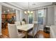 Dining room features hardwood floors, a stone-top table with seating for six, and lots of natural light at 580 Via Di Parione Ct, Henderson, NV 89011