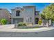 Two-story stucco home features stone accents, a two-car garage, beautiful landscaping, and a front courtyard at 580 Via Di Parione Ct, Henderson, NV 89011