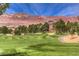 Picturesque golf course view with lush green fairways and mountain backdrop at 580 Via Di Parione Ct, Henderson, NV 89011
