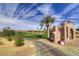 Scenic view of Chimera Golf Club with a well-manicured green, palms and desert landscape at 580 Via Di Parione Ct, Henderson, NV 89011