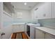 Convenient laundry room with white cabinets, countertops, shelves, and modern appliances at 580 Via Di Parione Ct, Henderson, NV 89011