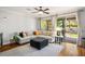 Living room with large sectional sofa, area rug, and outdoor patio access at 580 Via Di Parione Ct, Henderson, NV 89011