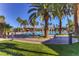 Resort-style pool area featuring palm trees and inviting cabanas for relaxation and entertainment at 580 Via Di Parione Ct, Henderson, NV 89011