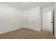 Simple bedroom with neutral carpet, closet, and ensuite access at 613 Kings Pl, Boulder City, NV 89005