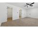 Large bedroom with neutral carpet and a walk-in closet, offering plenty of space at 613 Kings Pl, Boulder City, NV 89005