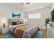 Bright bedroom featuring a large window, stylish decor, and a comfortable bed with blue carpet at 613 Kings Pl, Boulder City, NV 89005