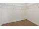 Walk-in closet with wire shelving, neutral carpet, and ample storage space at 613 Kings Pl, Boulder City, NV 89005