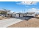 Charming home with a well-maintained lawn, front porch, and an attached carport for covered parking at 613 Kings Pl, Boulder City, NV 89005
