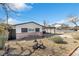 A beautiful home featuring desert landscaping, a brick facade, and an attached carport at 613 Kings Pl, Boulder City, NV 89005