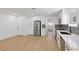 Open-concept kitchen featuring stainless steel appliances, sleek countertops, and hardwood floors, ideal for entertaining at 613 Kings Pl, Boulder City, NV 89005