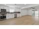 Spacious kitchen with stainless steel appliances and sleek countertops, seamlessly connected to the living area at 613 Kings Pl, Boulder City, NV 89005