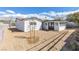 Back exterior featuring a large yard, a white exterior, and mature trees at 613 Kings Pl, Boulder City, NV 89005