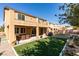 Well-maintained backyard featuring artificial turf, covered patio, mature trees, and a privacy wall at 6470 Crest Estates St, Las Vegas, NV 89131