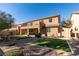 Large backyard featuring artificial turf, decorative rock, mature trees, shed, and privacy fence at 6470 Crest Estates St, Las Vegas, NV 89131