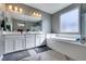 Elegant bathroom with a double vanity, soaking tub and stylish tile flooring at 6470 Crest Estates St, Las Vegas, NV 89131
