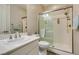 Well lit bathroom with glass enclosed shower, white vanity and sink at 6470 Crest Estates St, Las Vegas, NV 89131