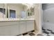 Bathroom featuring double sinks, stylish checkerboard flooring, and ample counter space at 6470 Crest Estates St, Las Vegas, NV 89131
