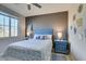 Bright bedroom with floral bedding, natural light, and calming blue accents at 6470 Crest Estates St, Las Vegas, NV 89131