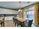 Light filled dining room with rustic wood table, backyard access, and modern chandelier at 6470 Crest Estates St, Las Vegas, NV 89131
