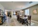 Open concept dining room with wood table, view into living room and plenty of natural light at 6470 Crest Estates St, Las Vegas, NV 89131