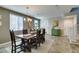 Inviting dining room with natural light, wood table, and stairs leading to upper levels at 6470 Crest Estates St, Las Vegas, NV 89131