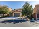 Two-story home with a three-car garage, stone accents and mature trees enhancing curb appeal at 6470 Crest Estates St, Las Vegas, NV 89131