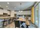 Spacious kitchen and dining area with white cabinets, granite countertops, and stainless steel appliances at 6470 Crest Estates St, Las Vegas, NV 89131