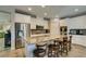 Modern kitchen with a large island, stainless steel appliances, and granite countertops at 6470 Crest Estates St, Las Vegas, NV 89131
