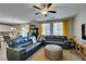 Cozy living room showcasing leather sofas, natural light and a ceiling fan for added comfort at 6470 Crest Estates St, Las Vegas, NV 89131